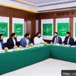 Home 18 목적 중심적 리더십의 역할 - A diverse Pakistani office team engaged in a collaborative meeting around a large table, with a conf...